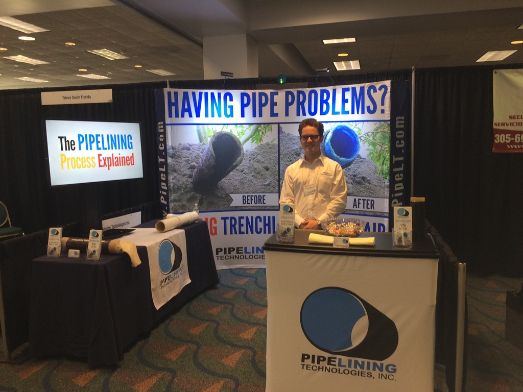 Parker Ruiz at a trenchless pipe lining trade show booth in 2016